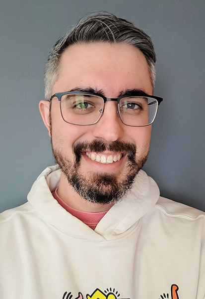 a man wearing glasses and looking at the camera