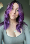 a woman wearing a purple shirt