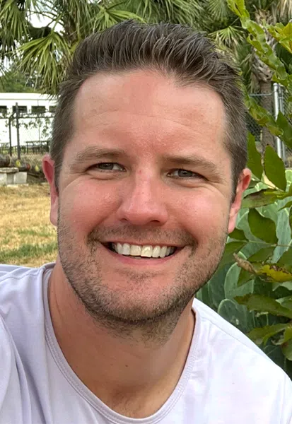 a close up of a man smiling for the camera