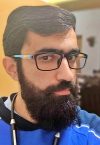 a close up of a man wearing glasses