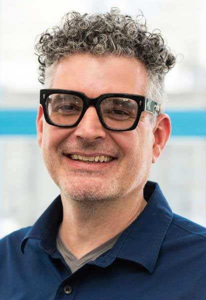 Steve Sartino wearing glasses and smiling at the camera