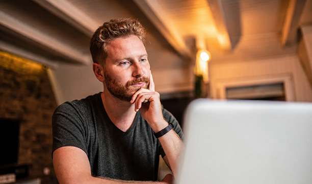 Man in Basement Studying Laptop